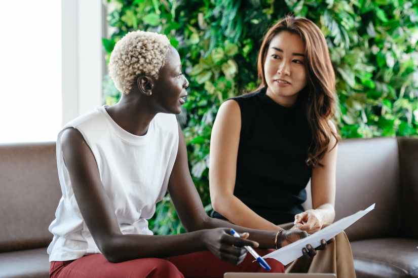 Two colleagues reviewing documents together